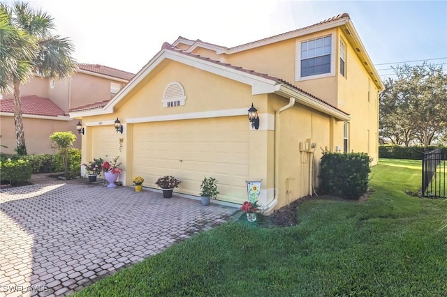 view of side of home featuring a garage and a yard