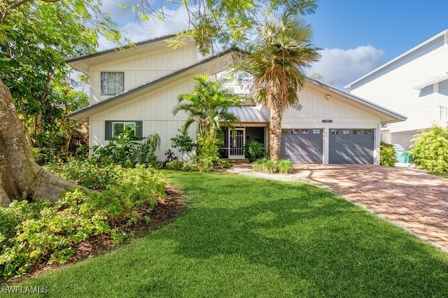 view of front of property with a garage and a front yard