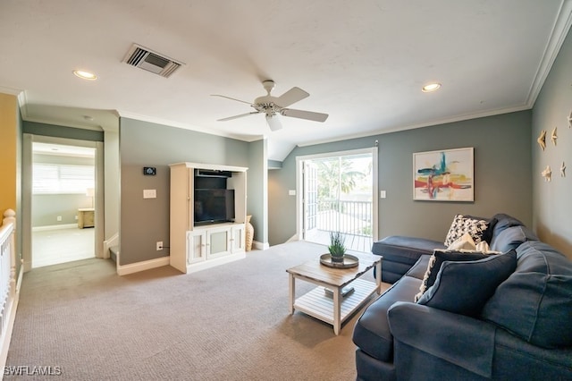 living room featuring light carpet, ceiling fan, and ornamental molding