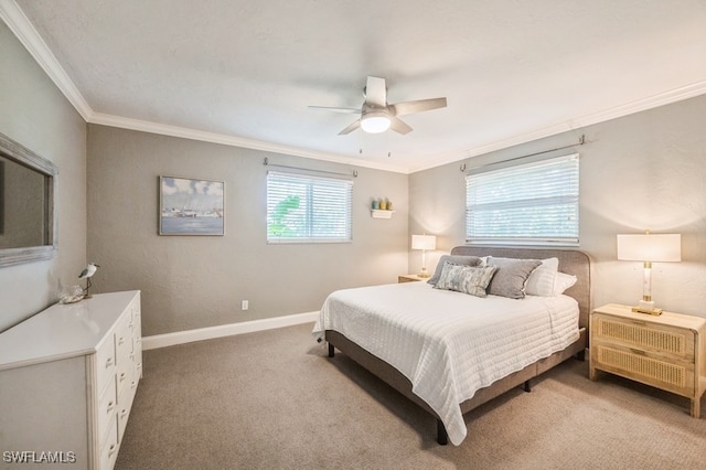 carpeted bedroom with ceiling fan and ornamental molding