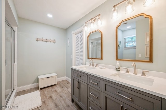 bathroom featuring vanity, hardwood / wood-style flooring, and an enclosed shower