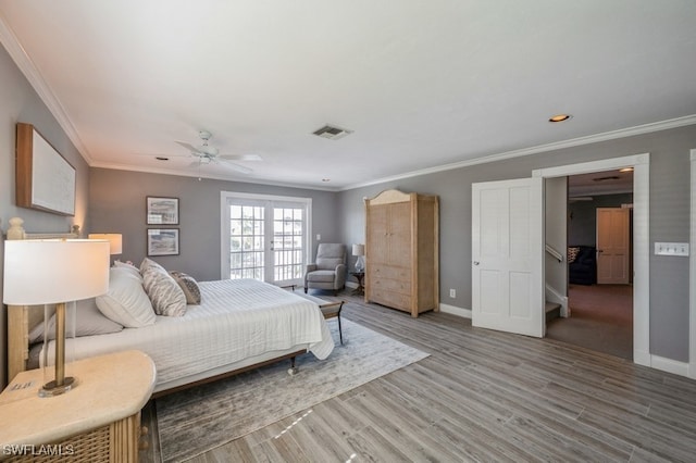 bedroom featuring hardwood / wood-style floors, ceiling fan, and ornamental molding