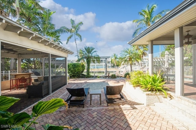 view of patio / terrace with a sunroom and a swimming pool