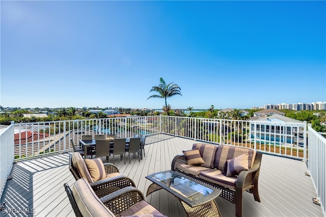 deck featuring an outdoor living space and a water view