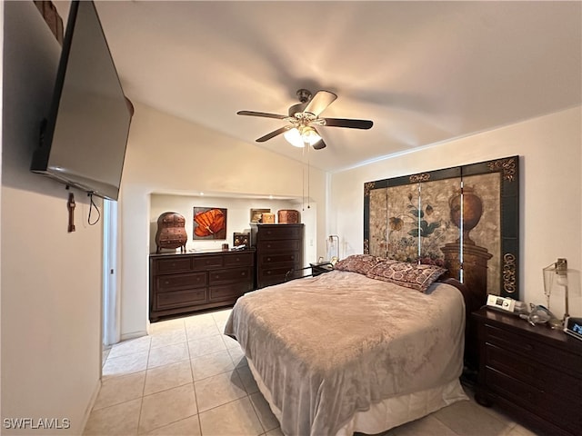 bedroom featuring ceiling fan, vaulted ceiling, and light tile patterned flooring