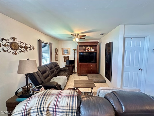 tiled living room with ceiling fan