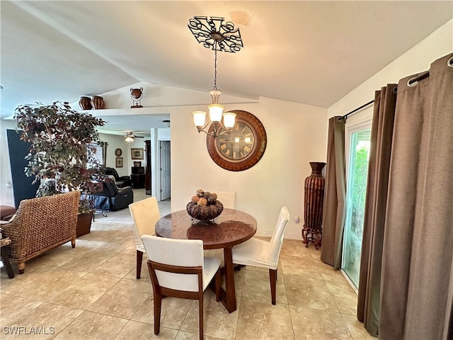 dining area featuring ceiling fan with notable chandelier, light tile patterned flooring, and vaulted ceiling