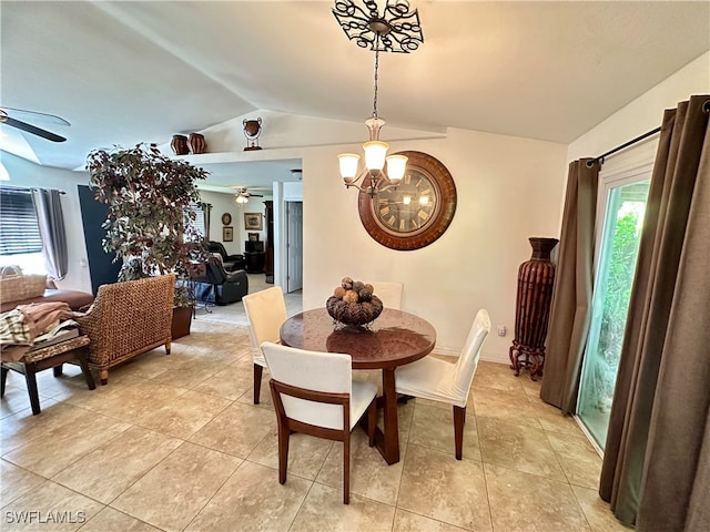 dining area featuring lofted ceiling, a healthy amount of sunlight, and ceiling fan with notable chandelier