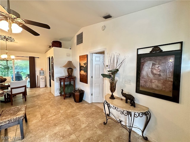 hallway featuring lofted ceiling and a notable chandelier