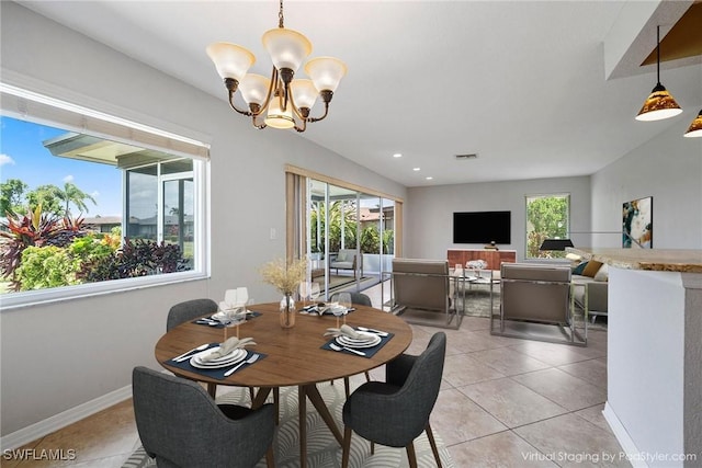 tiled dining area featuring an inviting chandelier