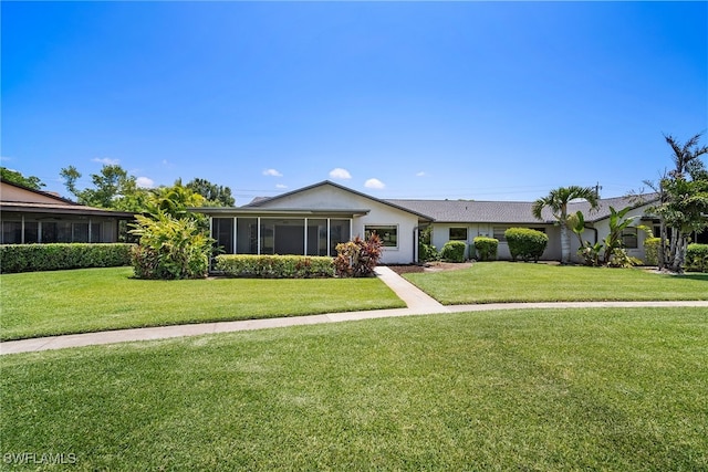 ranch-style house with a sunroom and a front yard