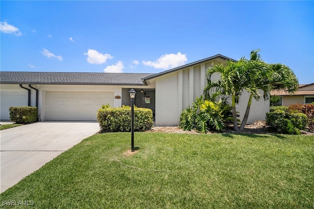 ranch-style house with a garage and a front lawn