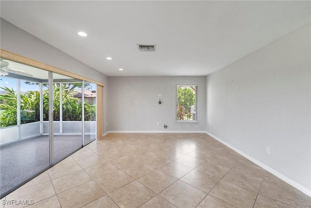 spare room featuring light tile patterned floors and ceiling fan