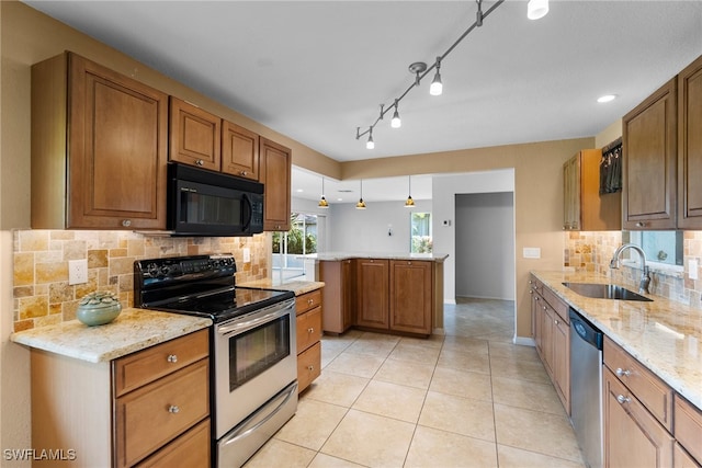 kitchen with kitchen peninsula, sink, electric stove, dishwasher, and hanging light fixtures