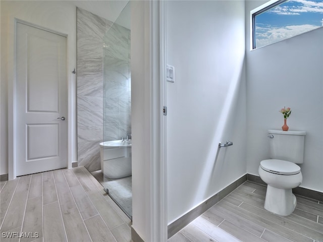 bathroom featuring a washtub and toilet