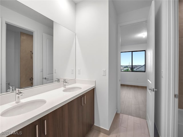 bathroom with a textured ceiling, shower / bath combination, vanity, and hardwood / wood-style flooring