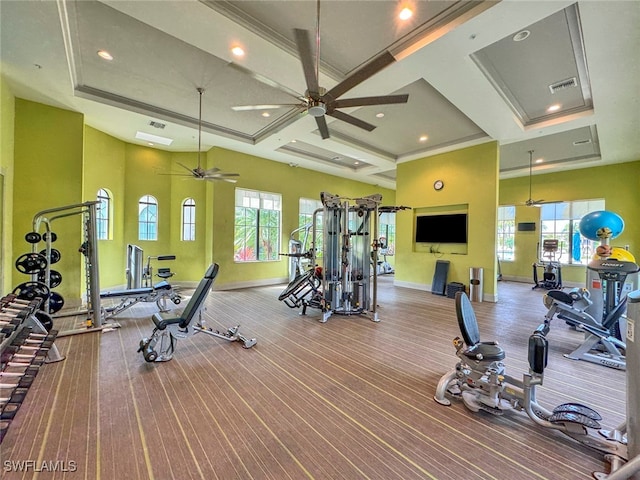 exercise room featuring coffered ceiling, ceiling fan, and ornamental molding