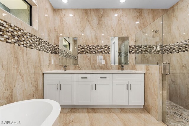 bathroom with vanity, plus walk in shower, and tile walls