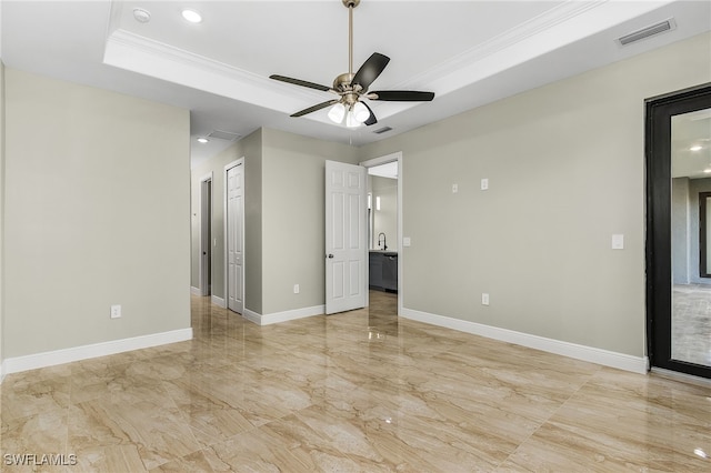 unfurnished bedroom featuring ornamental molding, ceiling fan, a raised ceiling, and sink