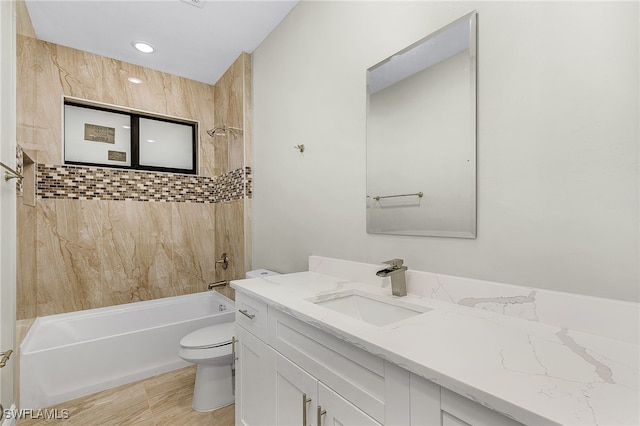 full bathroom with vanity, toilet, and tiled shower / bath combo