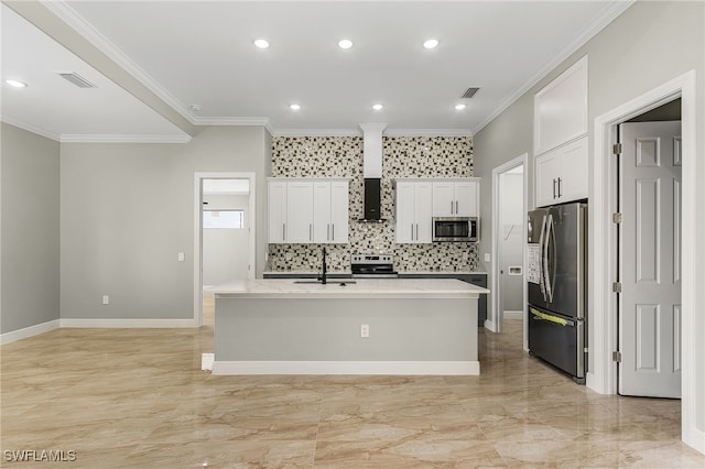 kitchen with sink, a kitchen island with sink, crown molding, white cabinetry, and appliances with stainless steel finishes