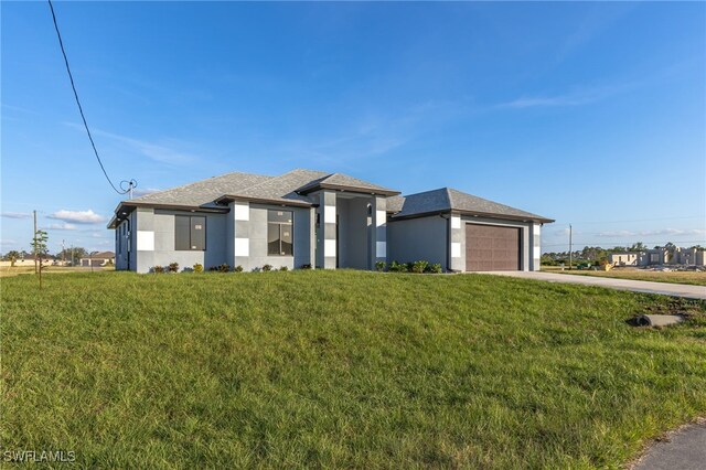 view of front facade with a garage and a front lawn