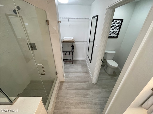 bathroom featuring walk in shower and toilet