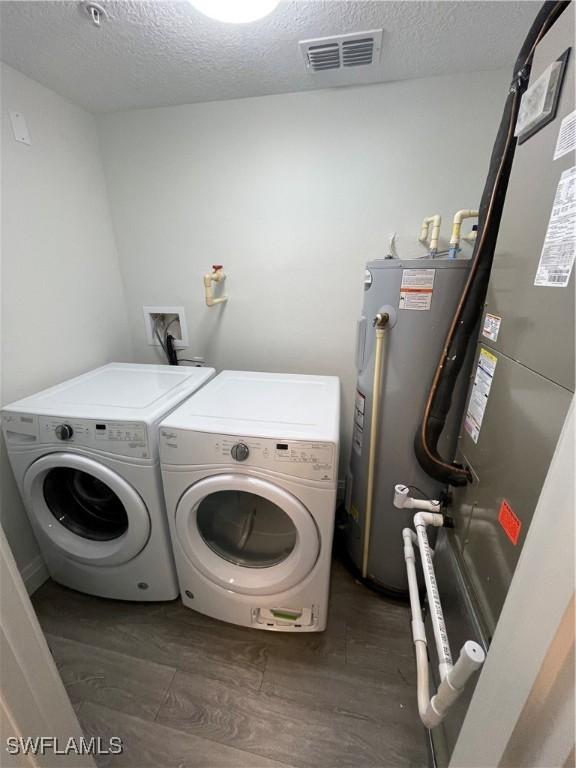 14501 Grove Resort Ave Unit 3712, Winter Garden, FL 34787 - laundry area with laundry area, visible vents, washer and dryer, a textured ceiling, and water heater