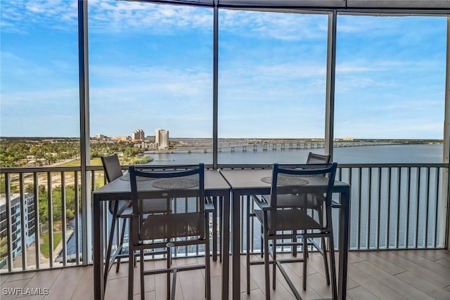 sunroom / solarium featuring a water view