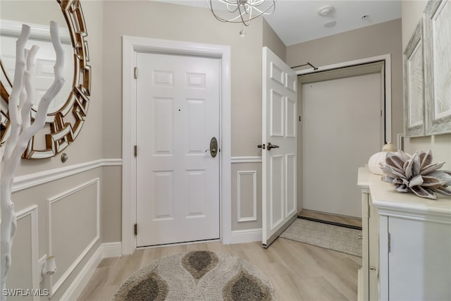 interior space featuring light hardwood / wood-style flooring and an inviting chandelier