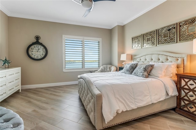 bedroom with ceiling fan, crown molding, and light hardwood / wood-style flooring