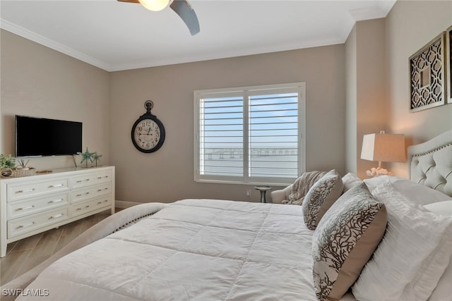 bedroom featuring wood-type flooring, ceiling fan, and ornamental molding