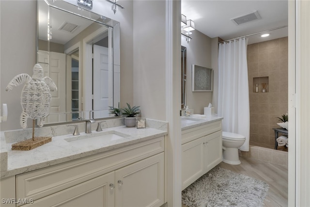 bathroom featuring hardwood / wood-style flooring, vanity, toilet, and a shower with shower curtain