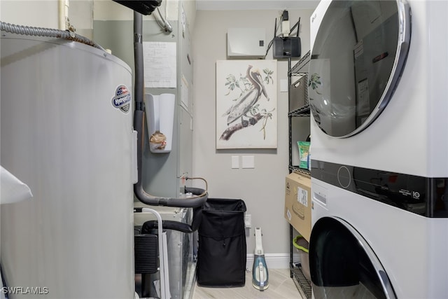 clothes washing area with stacked washer and dryer and water heater