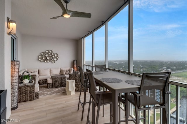 sunroom featuring ceiling fan