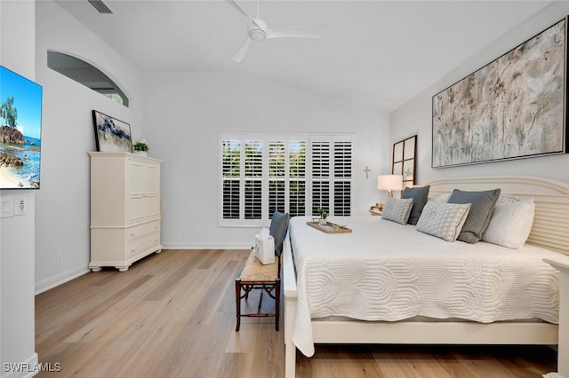 bedroom with ceiling fan, light hardwood / wood-style floors, and lofted ceiling