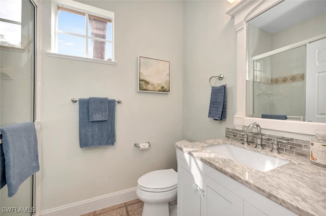 bathroom with tile patterned floors, vanity, tasteful backsplash, toilet, and a shower with shower door