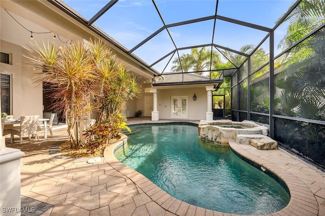 view of pool featuring french doors, a patio area, an in ground hot tub, and a lanai