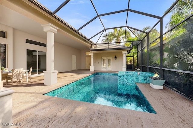 view of pool with a patio area, a lanai, and french doors