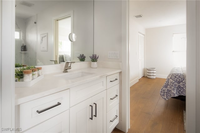 bathroom with vanity and hardwood / wood-style flooring