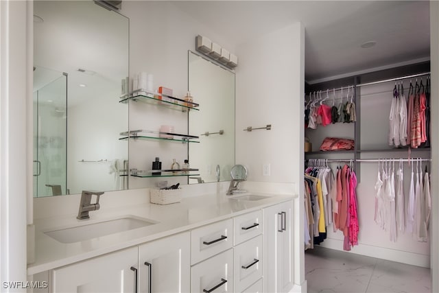 bathroom featuring a shower with door and vanity