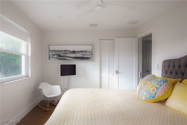 bedroom featuring wood-type flooring, ceiling fan, and a closet