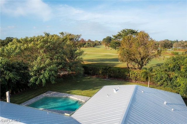view of pool featuring a hot tub, a lawn, and view of golf course