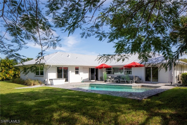 back of property featuring a lawn and a patio