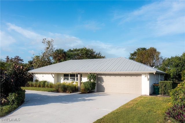 ranch-style home featuring a garage and a front yard