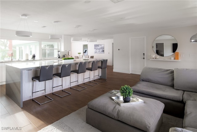 living room with sink and light hardwood / wood-style floors