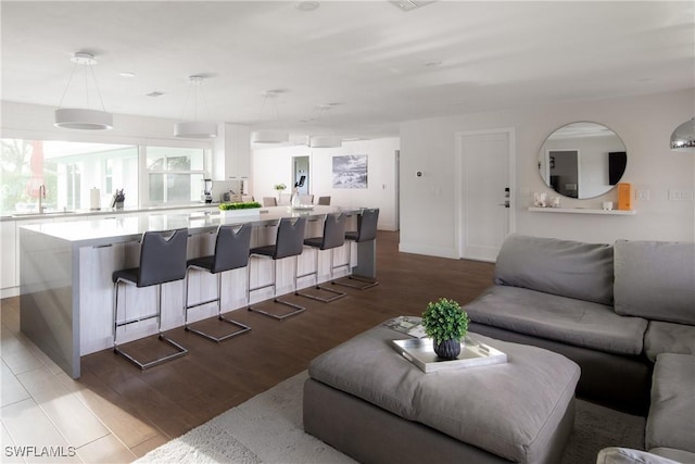 living area featuring baseboards and wood finished floors