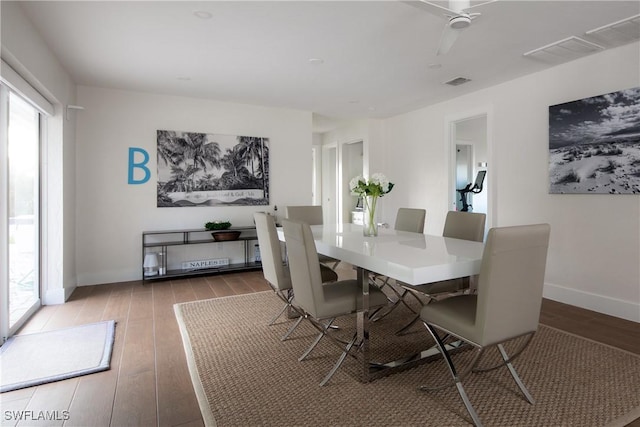 dining space featuring baseboards, visible vents, and wood finished floors