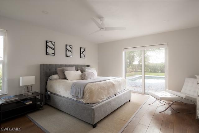 bedroom featuring ceiling fan, hardwood / wood-style flooring, access to exterior, and multiple windows