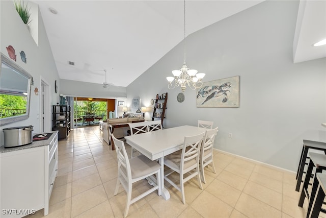 tiled dining area featuring ceiling fan with notable chandelier and high vaulted ceiling